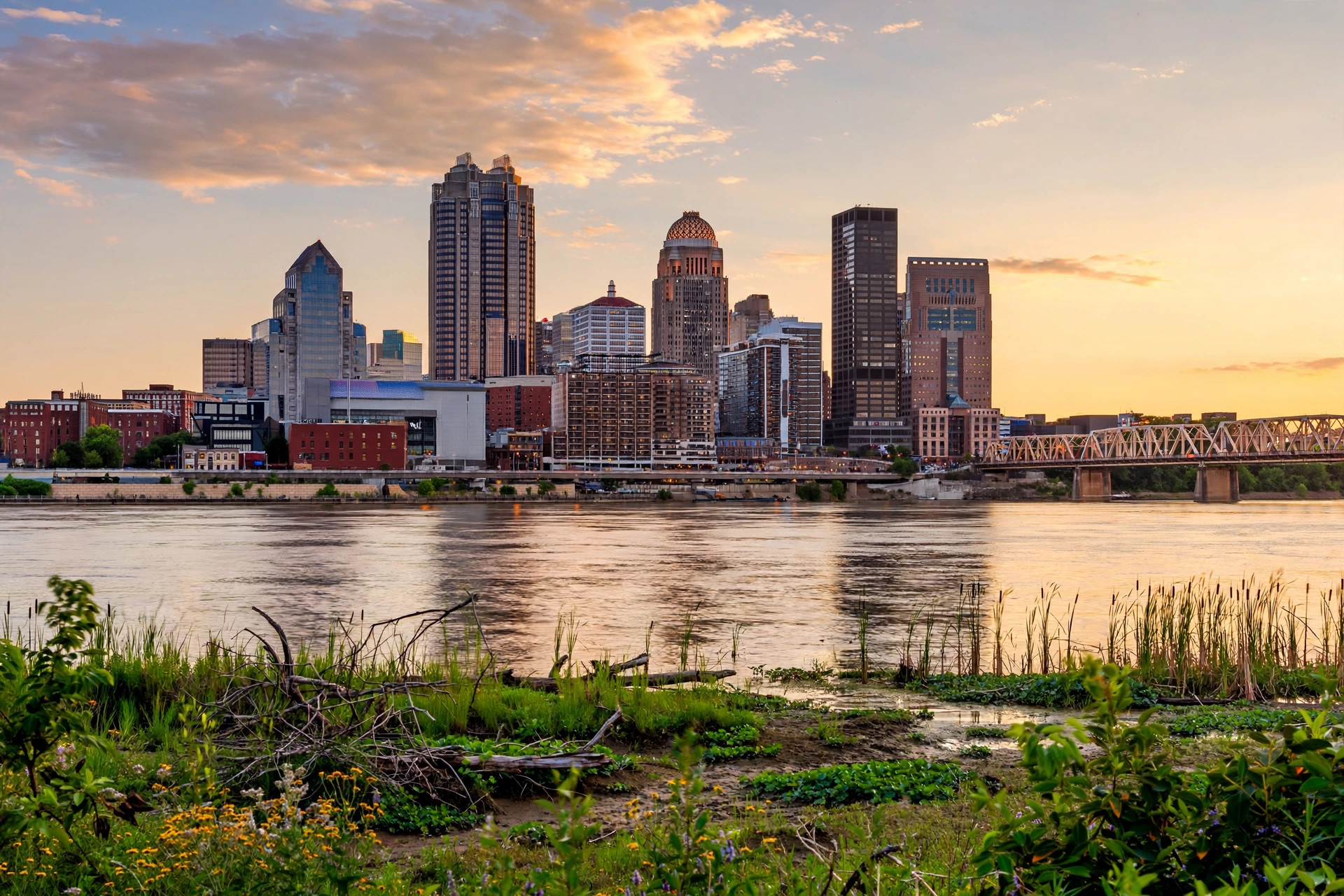 Illustrative view of the downtown Louisville skyline across the Ohio River at golden hour